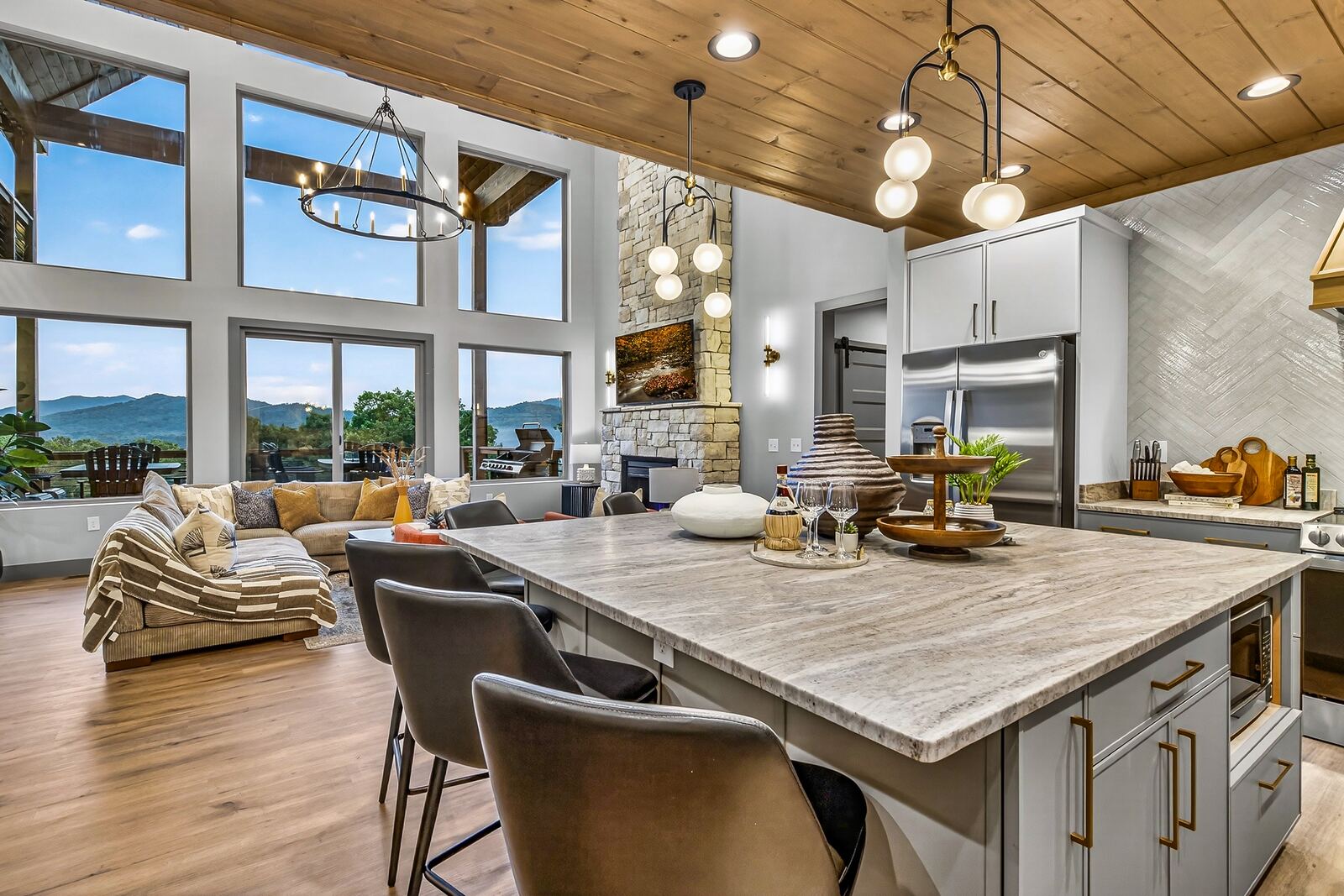 Great room with floor-to-ceiling windows and stone fireplace
